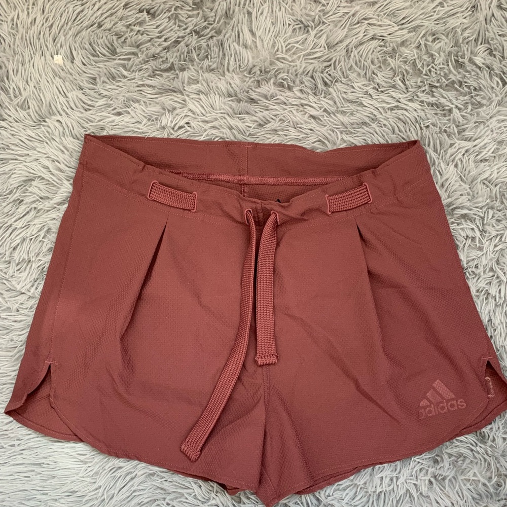 Red adidas running shorts